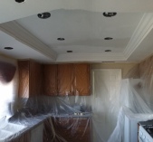 Here is the kitchen remodel after we installed the crown moulding in the recess to give it a richer appearance. 